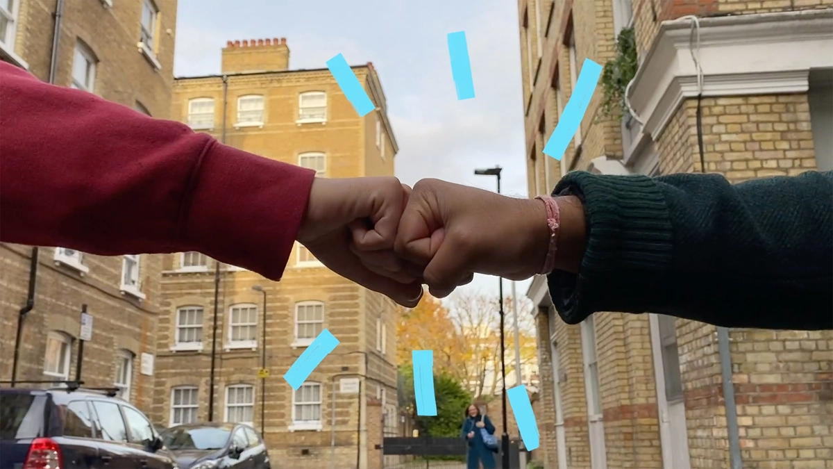 Photo: Scout24: 2 people fist bump each other on the street